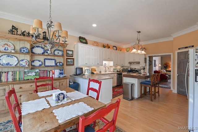 kitchen featuring white cabinetry, appliances with stainless steel finishes, a center island, and pendant lighting