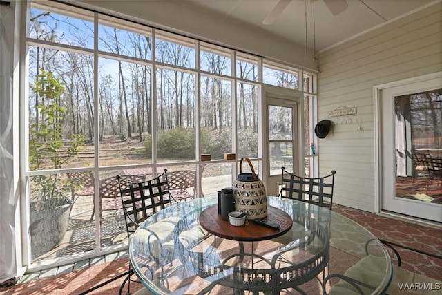 sunroom featuring ceiling fan