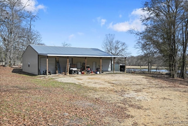 view of outbuilding with a water view and a garage