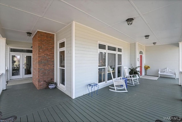 deck with covered porch and french doors