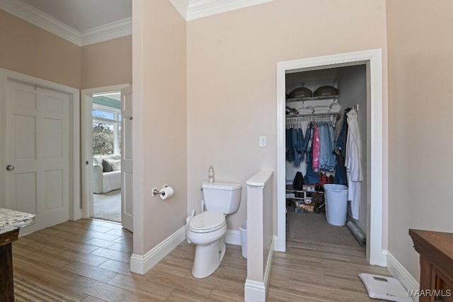 bathroom with vanity, hardwood / wood-style floors, crown molding, and toilet