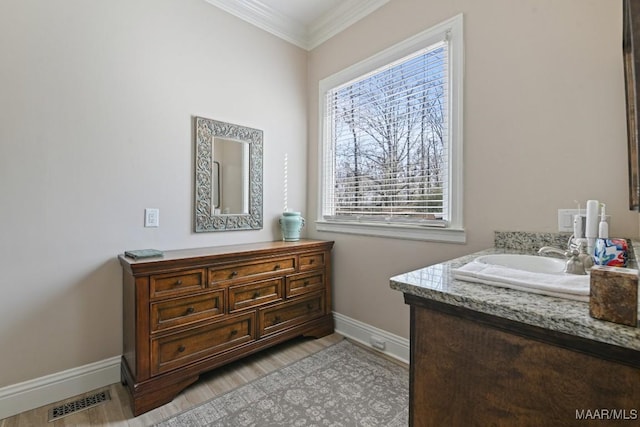 bathroom with ornamental molding, vanity, and hardwood / wood-style floors