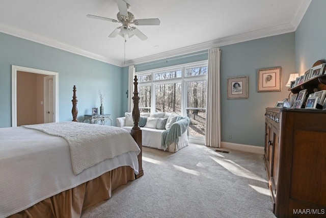 carpeted bedroom featuring ornamental molding and ceiling fan