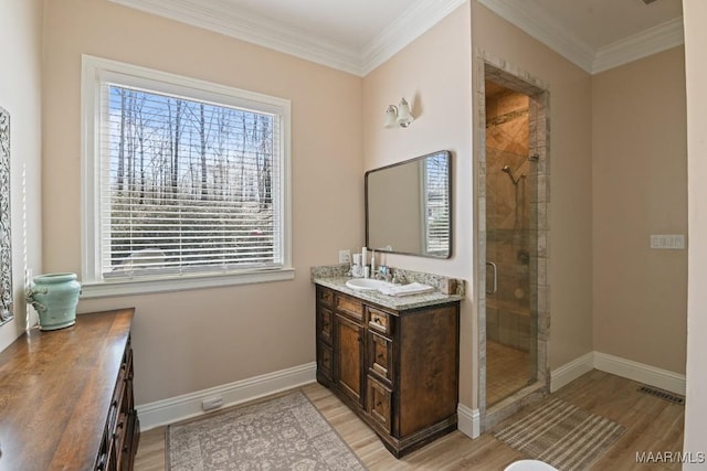 bathroom with vanity, hardwood / wood-style floors, crown molding, and walk in shower