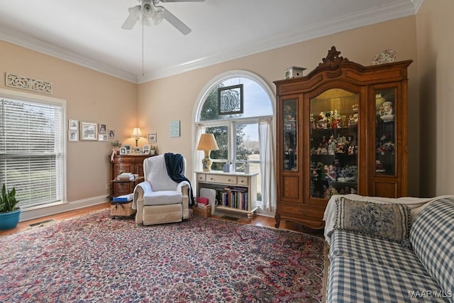 living area with crown molding, ceiling fan, and hardwood / wood-style floors