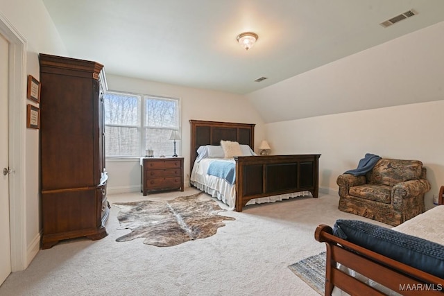 carpeted bedroom featuring lofted ceiling