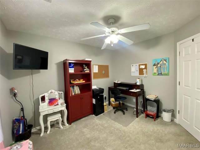 office with ceiling fan, light colored carpet, and a textured ceiling