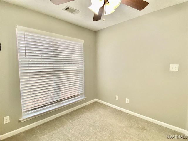 carpeted empty room featuring ceiling fan