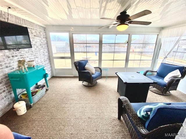 sunroom / solarium featuring ceiling fan