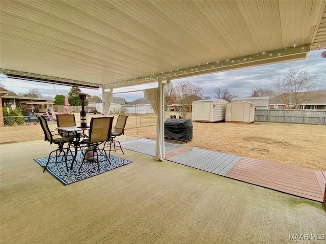 view of patio with area for grilling and a storage shed