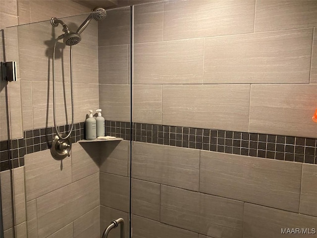 bathroom with a tile shower