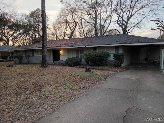 ranch-style house featuring a carport