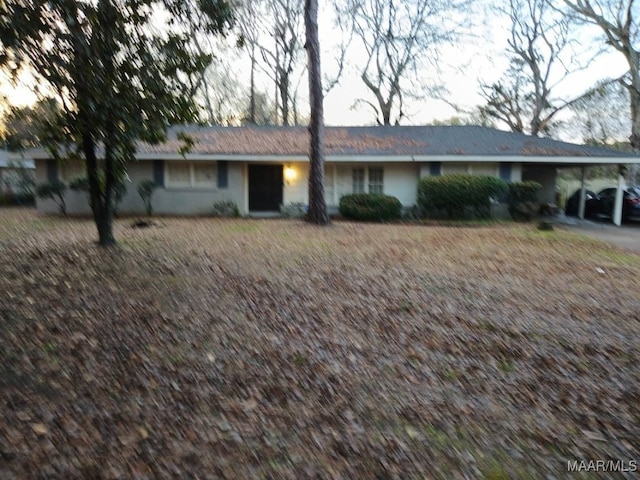 ranch-style home with a carport