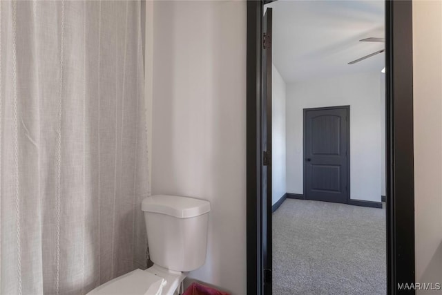 bathroom featuring ceiling fan and toilet