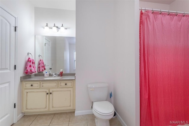 bathroom with tile patterned flooring, vanity, and toilet