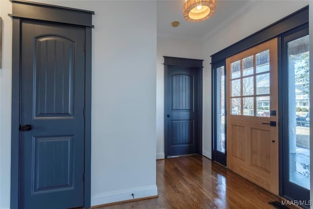 foyer featuring crown molding and dark hardwood / wood-style flooring