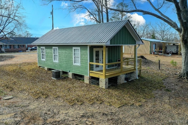 rear view of house featuring central AC