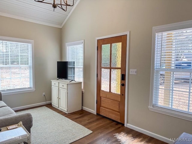 interior space featuring hardwood / wood-style floors, vaulted ceiling, and a chandelier