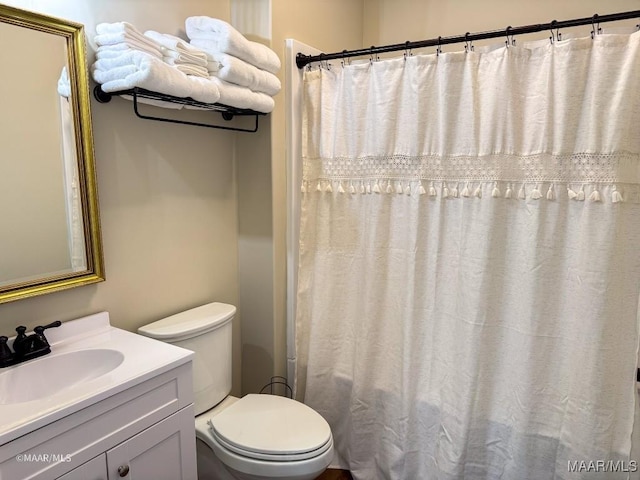 bathroom with vanity, curtained shower, and toilet