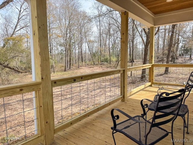 unfurnished sunroom with wood ceiling