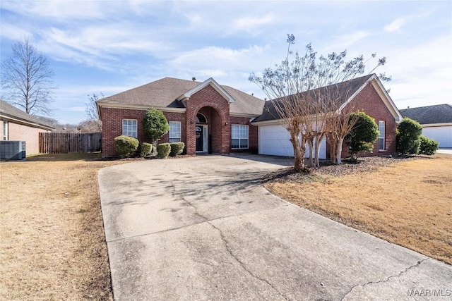 view of front of home featuring a garage and cooling unit