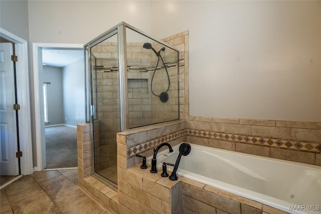 bathroom featuring shower with separate bathtub and tile patterned flooring