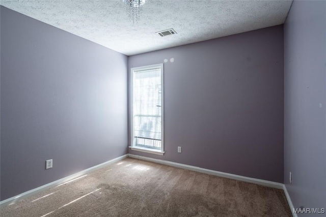 unfurnished room featuring carpet floors and a textured ceiling