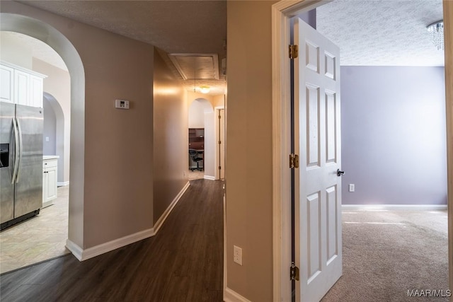 hall featuring dark hardwood / wood-style floors and a textured ceiling