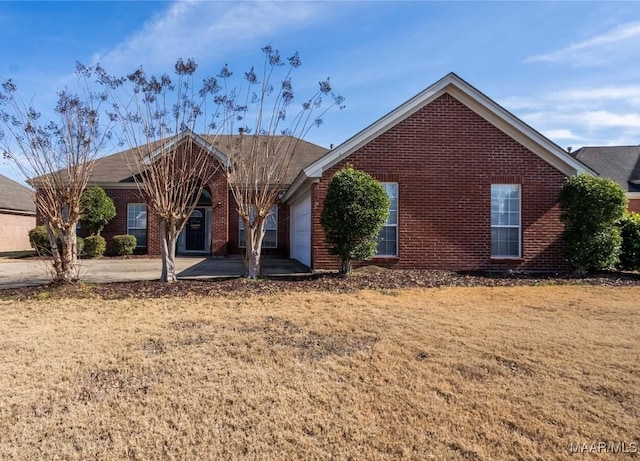 view of front of home with a garage, a front lawn, and a patio