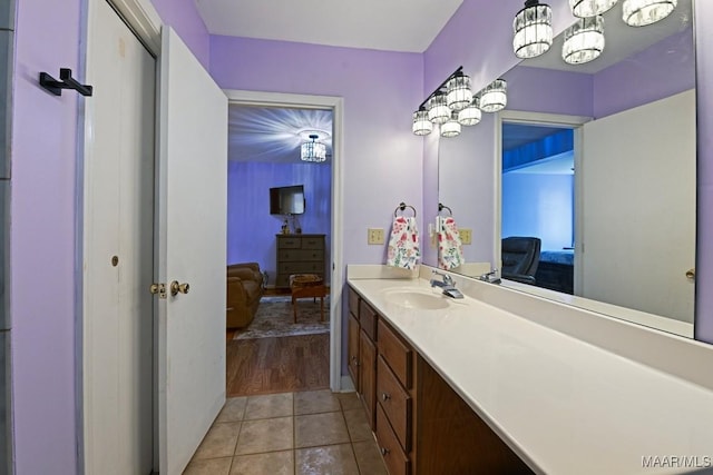 full bath featuring tile patterned flooring, connected bathroom, and vanity