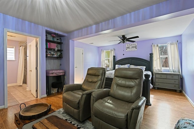 bedroom featuring light wood-style floors, baseboards, and a ceiling fan