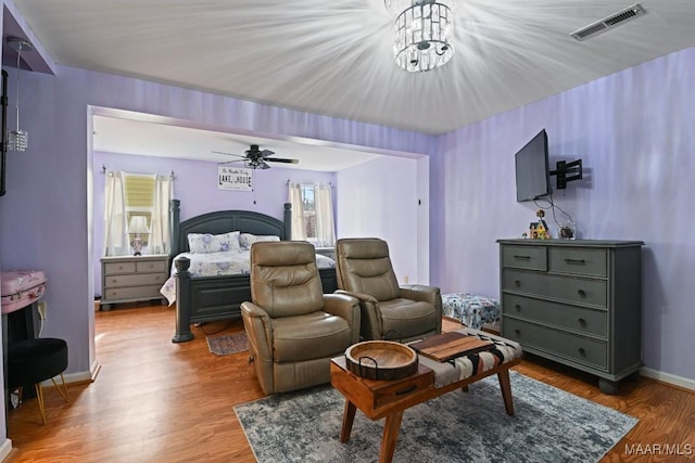 bedroom with light wood-type flooring, visible vents, and baseboards