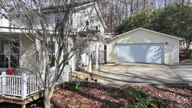 view of property exterior featuring an outdoor structure and a detached garage