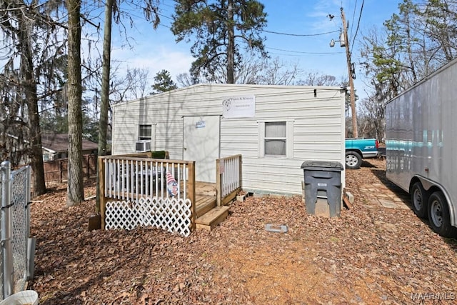 rear view of house featuring fence