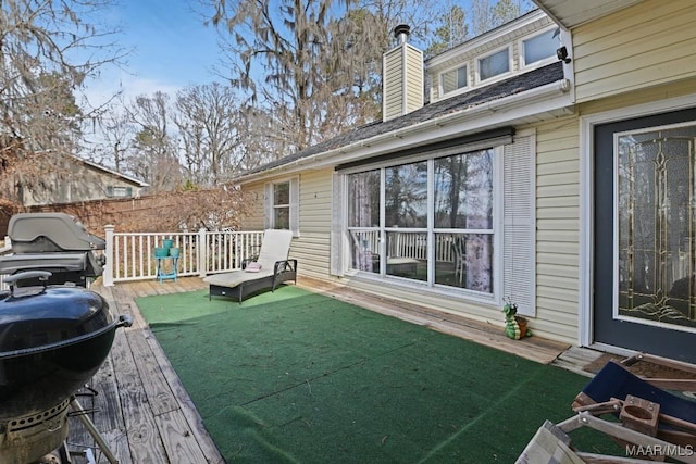 deck featuring area for grilling and fence