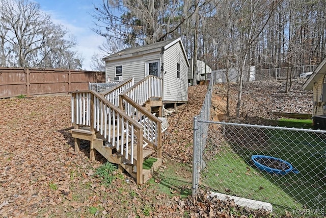 back of house with a fenced backyard