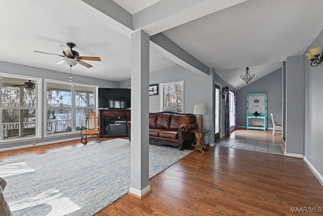 foyer entrance featuring dark wood-style floors, vaulted ceiling with beams, a ceiling fan, and baseboards