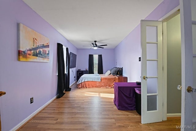 bedroom featuring ceiling fan, wood finished floors, and baseboards