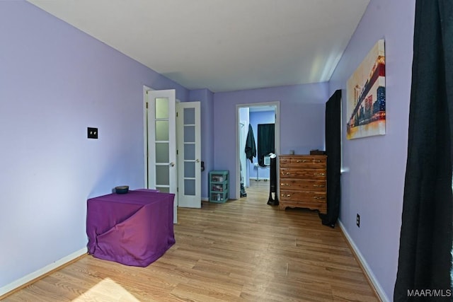 bedroom featuring baseboards and wood finished floors