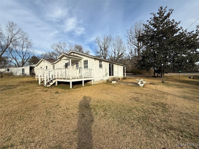 view of home's exterior featuring a yard and a deck