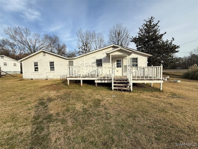 rear view of property with a wooden deck and a yard