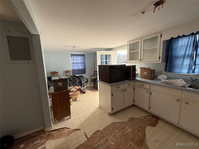 kitchen with white cabinetry and electric panel