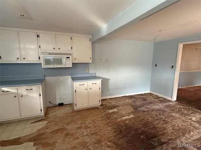 kitchen with white cabinetry and hardwood / wood-style floors