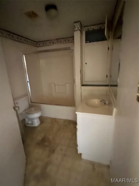 full bathroom featuring washtub / shower combination, vanity, and toilet