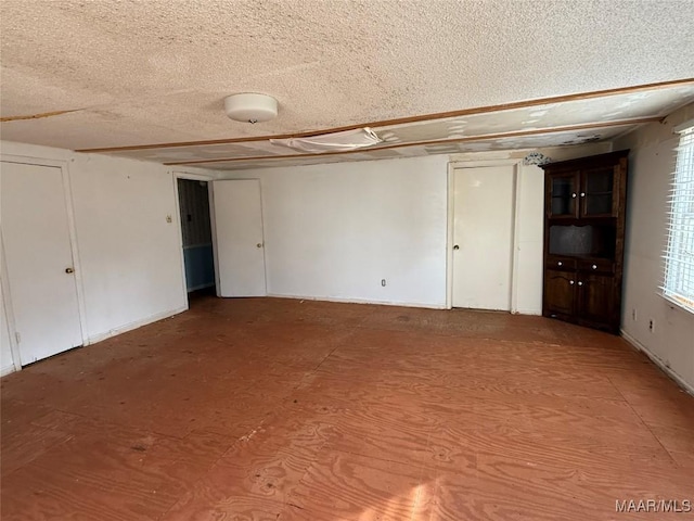 unfurnished room with a textured ceiling