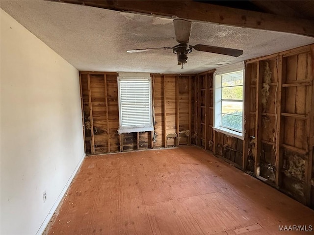 miscellaneous room with ceiling fan and a textured ceiling