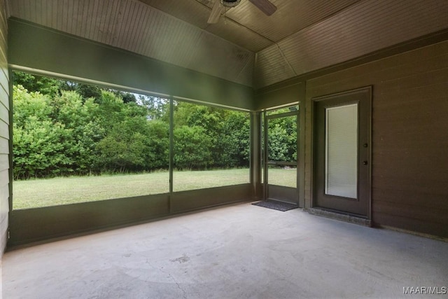 unfurnished sunroom with ceiling fan and lofted ceiling