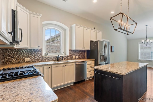 kitchen with a notable chandelier, a sink, plenty of natural light, and stainless steel appliances