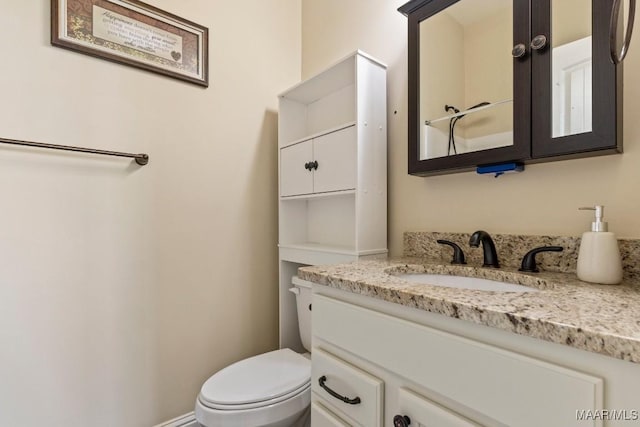 bathroom featuring toilet and vanity