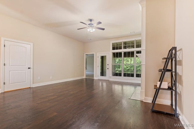 unfurnished room featuring dark wood-type flooring and ceiling fan